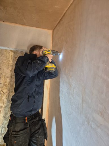 Student at Oakmoor AP using a cordless drill to secure materials during a construction task.
